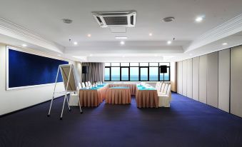 A spacious room is arranged with tables and chairs for hosting events or functions at Hotel Sentral Seaview @ ​Beachfront
