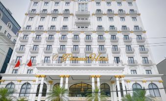 "a large white building with the name "" pierre hotel "" on it , surrounded by palm trees and other greenery" at Phoenix Hotel Hà Giang