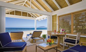 a beach house with an open floor plan , allowing for easy living and a view of the ocean at Four Seasons Resort Nevis