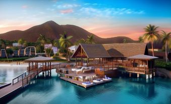 a resort with a large deck and multiple boats , surrounded by palm trees and mountains at Park Hyatt St Kitts Christophe Harbour