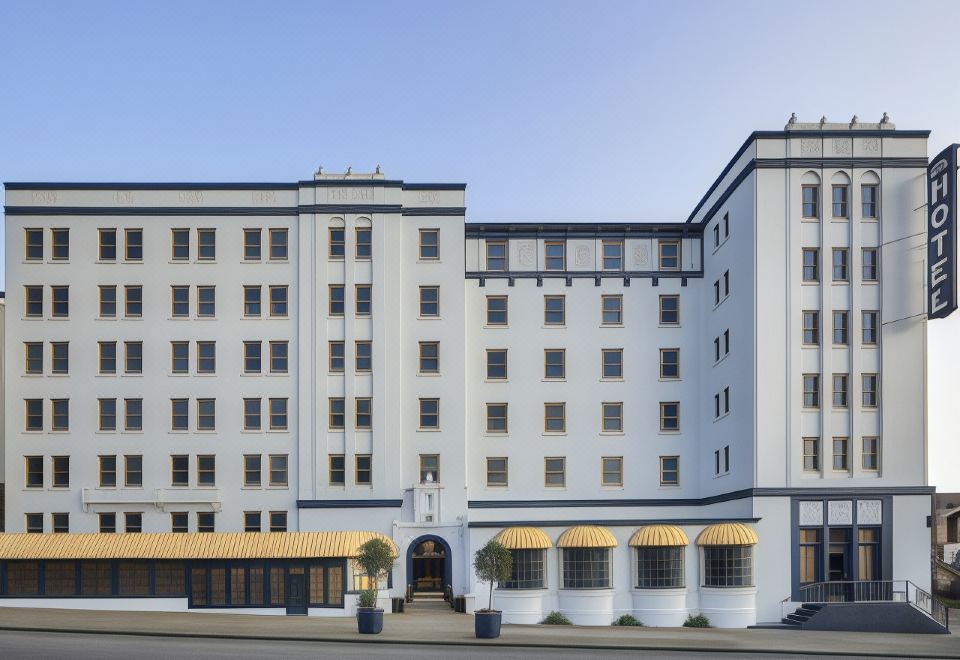 "a large white building with yellow awnings and a sign that says "" the hampton inn ""." at Graduate Berkeley