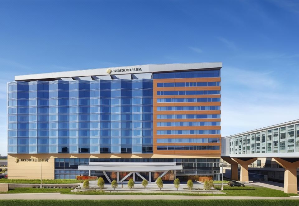 a large , modern hotel building with a blue glass facade and a clear sky in the background at InterContinental Hotels Minneapolis - ST. Paul Airport