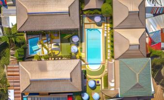 an aerial view of a residential area with multiple houses , a pool , and a parking lot at Scent of Green Papaya