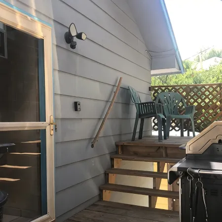 Covered parking/3 bedrooms, sitting room, restroom w/laundry, full kitchen, deck