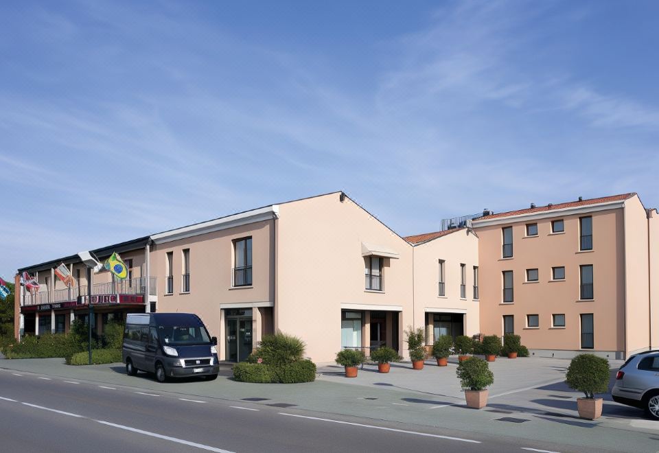 a city street with a van parked on the side of the road , and a group of people standing in front of a building at Best Western Titian Inn Hotel Venice Airport