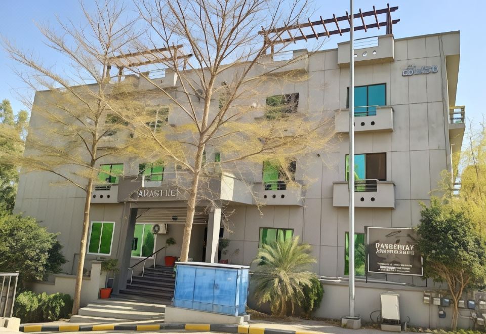 "a large white building with green windows and a sign that says "" alabama "" on the side" at Parkway Apartments