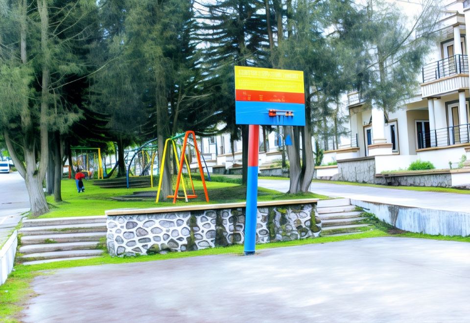 a colorful playground with various play structures , such as swings , slides , and climbing structures , situated in a park - like setting at Villa Berastagi Highland