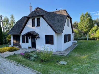 Large Thatched-Roof Vacation Home at the Wolin National Park View of Lake Neuendorf