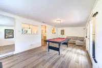 King bed with Pool table, decked patio and, gym.