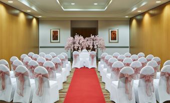 a wedding ceremony taking place in a hotel ballroom , with chairs set up for guests at Leonardo Hotel Middlesbrough - Formerly Jurys Inn