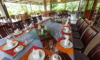 a large dining room with multiple tables set for a meal , each table having its own set of cutlery and wine glasses at Nakakiri Resort & Spa