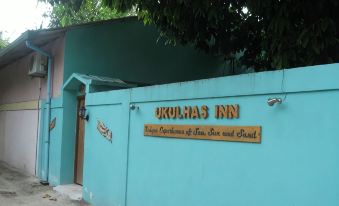"a building with a blue wall and a sign that reads "" akolhas inn "" on it" at Beach Villa Ukulhas