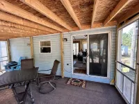 Parkmodel cabin w screened porch in campground on bike trail.