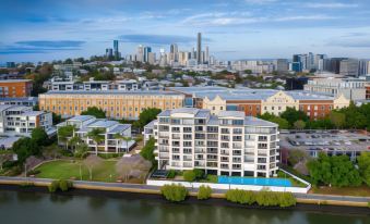 a bird 's eye view of a city with a large white building and a pool at Goldsborough Place Apartments
