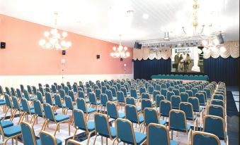 a large conference room filled with rows of blue and white chairs , ready for a meeting or event at Playadulce