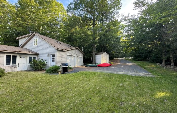 Stunning lakefront home with a boathouse, private dock, firepit and lake views