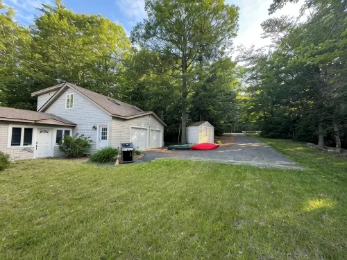 Stunning lakefront home with a boathouse, private dock, firepit and lake views