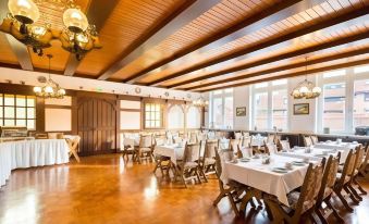 a large dining room with wooden tables and chairs , all set up for a formal event at Hotel zur Post