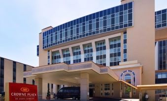 "a modern hotel with a large glass facade and a sign reading "" crowne plaza "" in front" at Clayton Plaza Hotel & Extended Stay