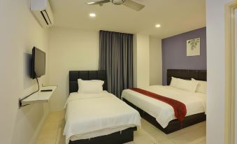 a hotel room with two beds , a tv , and a ceiling fan , decorated in white and black colors at Havona Hotel - Kulai
