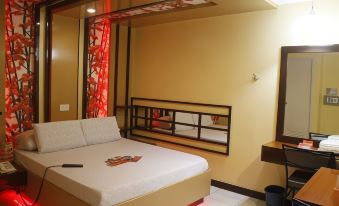 The bedroom features two beds and an open window beside someone's bedside at Hotel Sogo - Monumento, LRT Station