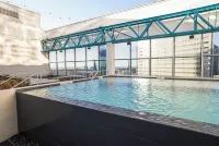 Cozy Retreat with Rooftop Pool, Parking, and Spacious Comfort - Condos