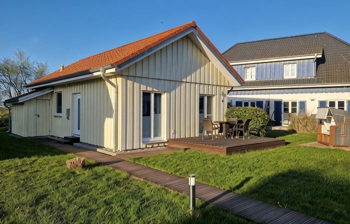Close to the beach holiday home in a quiet field location with a spacious wooden terrace