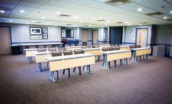 a large conference room with multiple rows of chairs arranged in a semicircle around a long table at Country Inn & Suites by Radisson, Burlington (Elon), NC