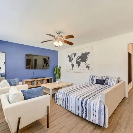 King bed with Pool table, decked patio and, gym.
