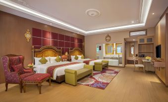 a modern hotel room with two beds , wooden flooring , and red - tiled walls , as well as a seating area at Ramada Suites by Wyndham Solo