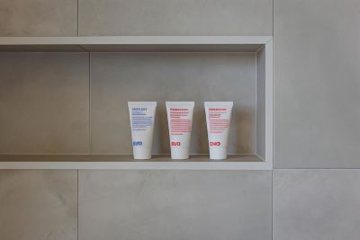 three tubes of oyo shampoo on a shelf in a bathroom , accompanied by a toothbrush and toothpaste at Oval Hotel at Adelaide Oval, an EVT hotel