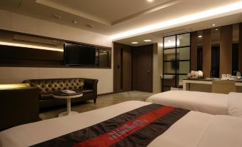 The bedroom features two beds with a flat-screen TV attached to the wall in the center at Hotel Zenith