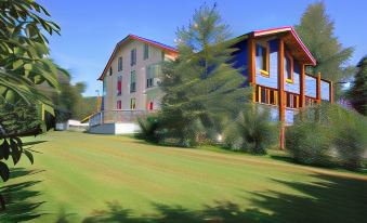 a large , colorful building with a red roof and white walls is surrounded by green grass and trees at La Residence - Logis de France