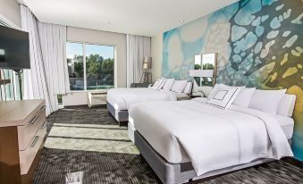 a hotel room with two beds , one on the left and one on the right side of the room at Courtyard Columbia Cayce