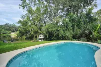 Mid-Century Boho Chic home with Pool, Game Room & Outdoor Playhouse.