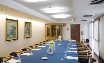 a long dining table set up for a formal event , with multiple chairs arranged around it at Parador de Mojacar