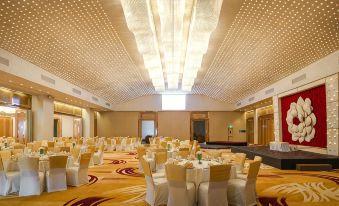 a large , well - decorated banquet hall with numerous tables and chairs set up for a formal event at Marino Beach Colombo
