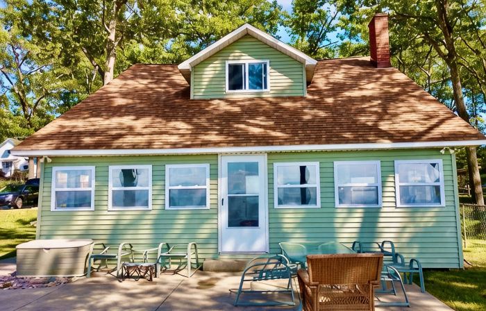New Listing! Lake front cottage with 100' of private sandy beach