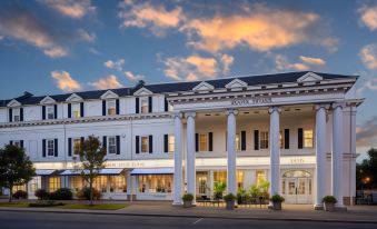 "a large white building with a sign that says "" hotel plaza "" is on the side of the road" at Historic Boone Tavern