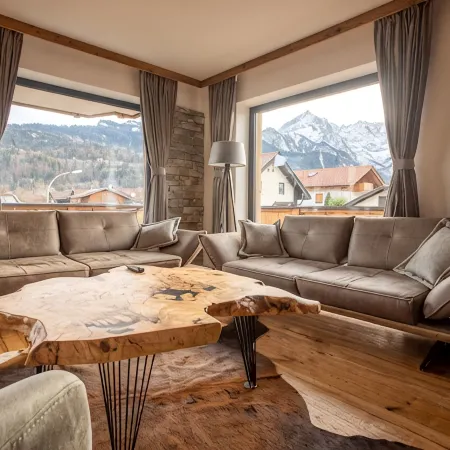 Modern chalet with a wraparound balcony with majestic views of the mountains