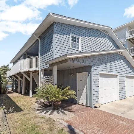 Located directly on canal w/ beautiful water front views — one block from beach