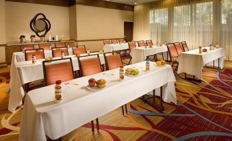 a conference room with tables set up for a meeting , including food and drinks on the table at Courtyard Lufkin