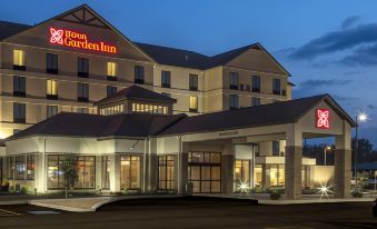 "a large hotel with a red sign that says "" boston garden inn "" is shown at night" at Hilton Garden Inn Uniontown