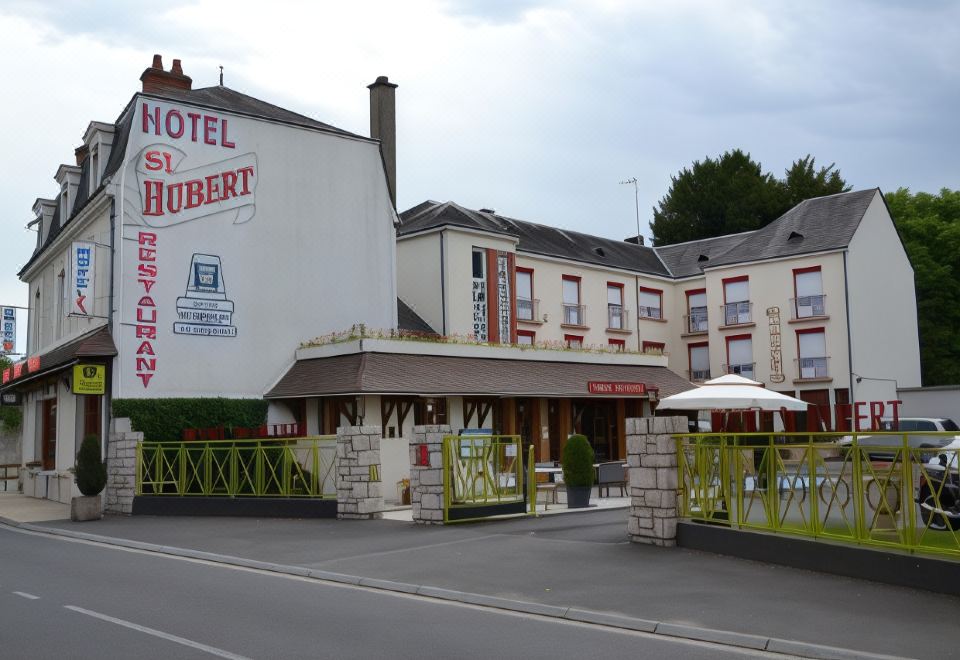 "a hotel with a large sign that says "" hotel la hubert "" is shown next to a street" at Hôtel Saint-Hubert