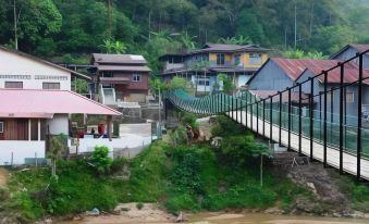 a group of houses on a hill overlooking a river with a bridge in the foreground at Casa Hill Resort