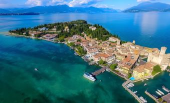 an aerial view of a small island with a bridge and boats in the middle of a large body of water at Hotel Eden