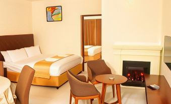 a hotel room with a bed , chairs , and a fireplace is shown in the image at Park Royale