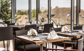 a dining room with several tables and chairs set up for a formal event , possibly a wedding reception at Hotel Ambassador