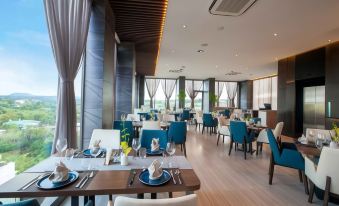 a modern dining room with blue and white decor , large windows , and wooden floors , as well as several tables set for guests at Boston Hotel