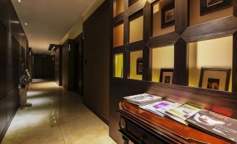 The hallway features wood paneling and a centrally located illuminated wall that has been painted at Hotel Zenith